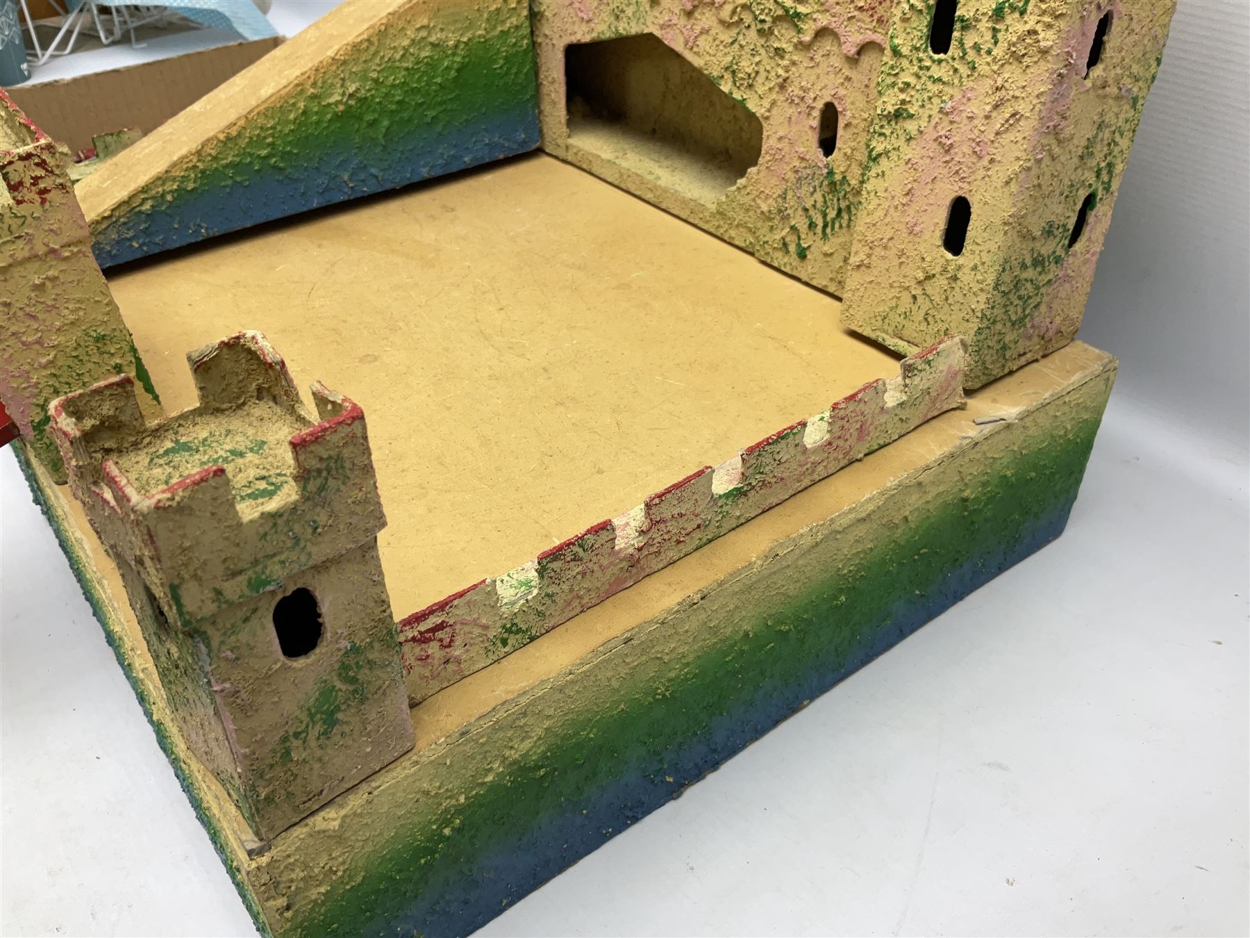 Sectional wooden fort on base with painted textured finish 46 x 36cm; together with over thirty lead and die-cast white metal soldiers and horses by various makers; and a small quantity of plastic figures of soldiers