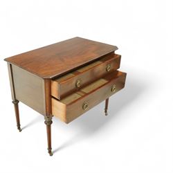 Early 20th century Regency-inspired mahogany two-drawer chest, rectangular top with moulded edge and shaped corners, above two full-width graduated drawers with ring handles, supported on turned tapered legs with brass castors                                                                                                                                                      
