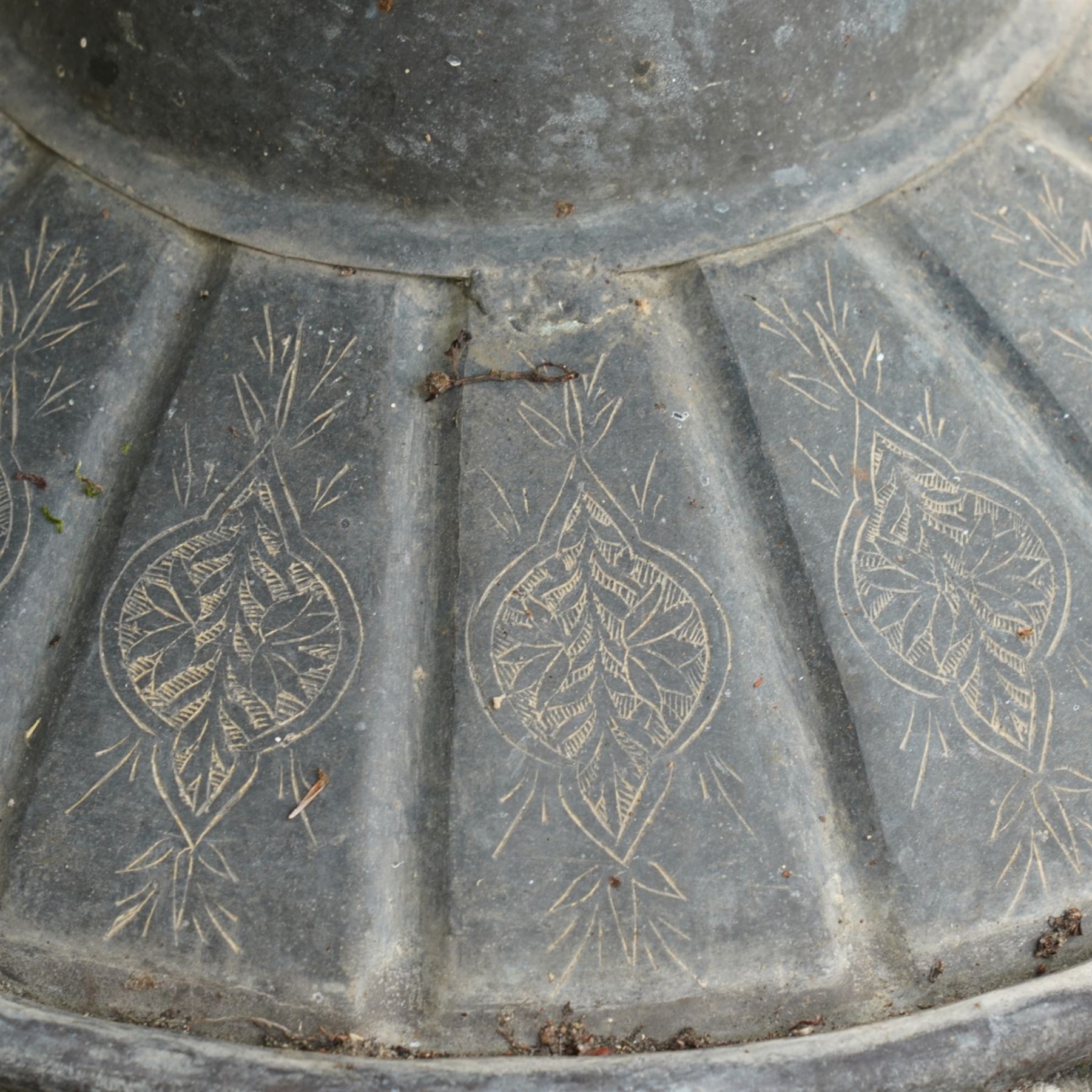 Pair of large Indian cast metal garden urns, each of bulbous form with engraved foliate and script panels, twin ring handles to the neck, raised on fluted pedestal bases