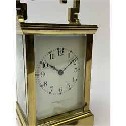 Early 20th century brass and bevelled glass carriage clock, angular handle with reeded cylindrical centre piece, the Arabic dial signed 'Goldsmith & Silversmith Co. Ltd, 112 Regent Street, London', twin train driven movement striking the hours and half on coil, with presentation inscription to top