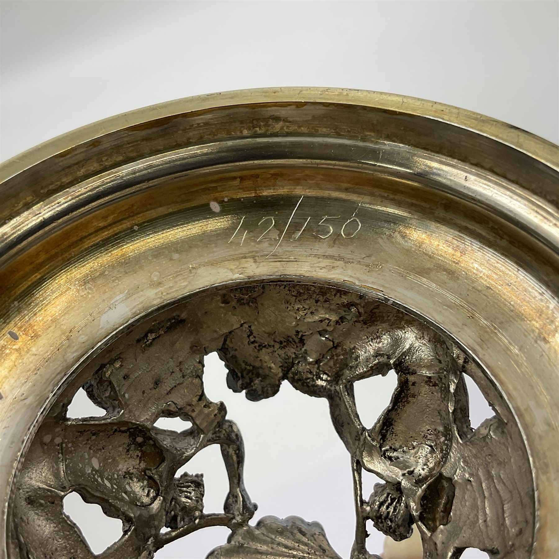 Modern limited edition silver mounted nautilus shell cup, no. 42/150, the pearlescent shell cup with silver-gilt strapwork to rim, upon a stem modelled as a putto supporting a gilt cornucopia and circular domed foot depicting Poseidon amongst swirling waves, hallmarked by St James House Company, London 1980,  H17.5cm