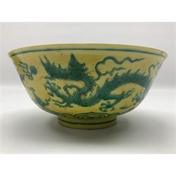 Pair of Chinese famille jaune bowls, decorated in green enamel with a dragon chasing a flaming pearl amongst clouds, upon a yellow ground, the interior decorated to centre with dragon, with six character mark beneath, D17.5cm