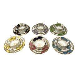 Five Coalport trios decorated in floral sprays with gilt in various colours, together with matching sugar bowl, dessert plate and saucer