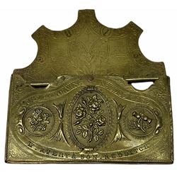 Victorian W Avery & Son of Redditch brass revolving needle case, with three panels of flowers representing the Union, roses, shamrocks and thistles, and further foliate and scrolling decoration throughout, H5cm W9cm 
