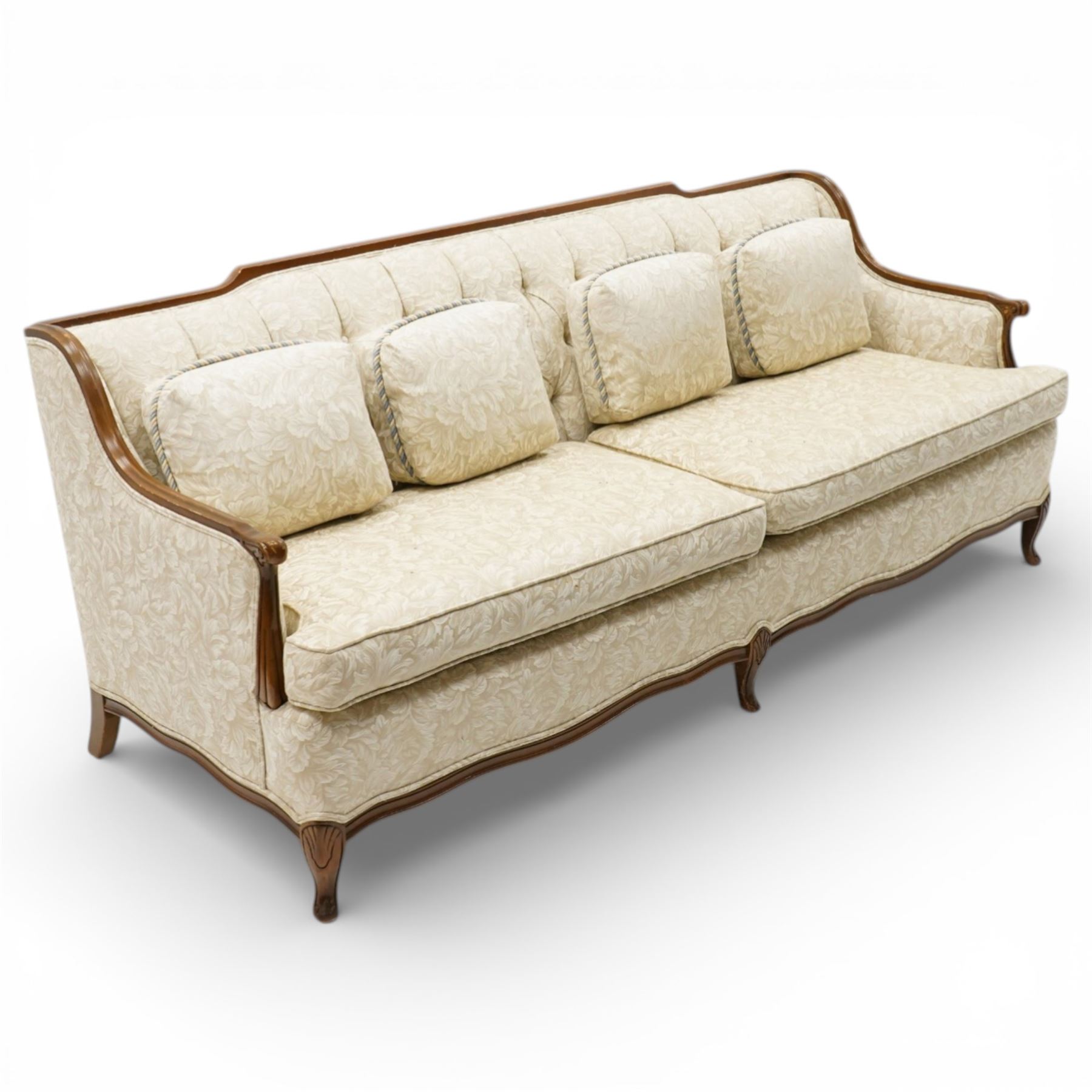 Mahogany framed three seat sofa in the Louis XV style, the shaped buttoned back above loose seat cushions and scrolling arms, raised on cabriole legs with shaped apron
