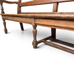 Early 20th century pine and oak bench seat, stained pine rail back frame with shaped oak arms