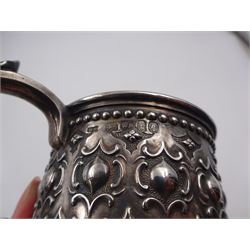 Victorian silver christening mug, with repousse and chased scroll and bead decoration, lozenge shaped cartouche engraved with monogrammed initials and acanthus capped C scroll handle, hallmarked Robert Hennell III, London 1861, H9.3cm