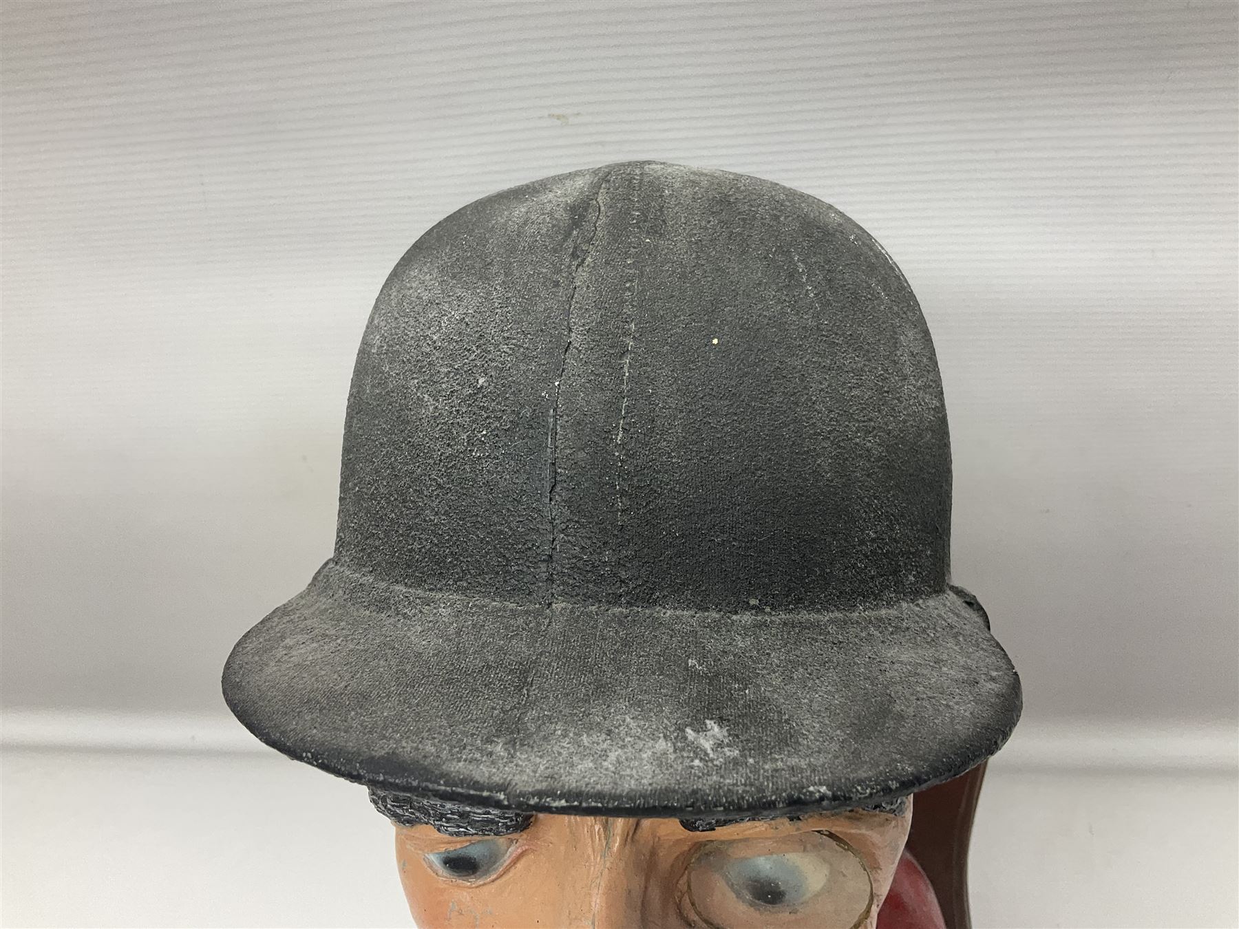 Composite figure of the head of a huntsman on a shield 'Caught by the Fox', D28cm