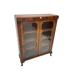 Early 20th century Art Deco walnut and mahogany bookcase, fitted with two astragal glazed doors enclosing three shelves, flanked by column uprights, on cabriole feet 