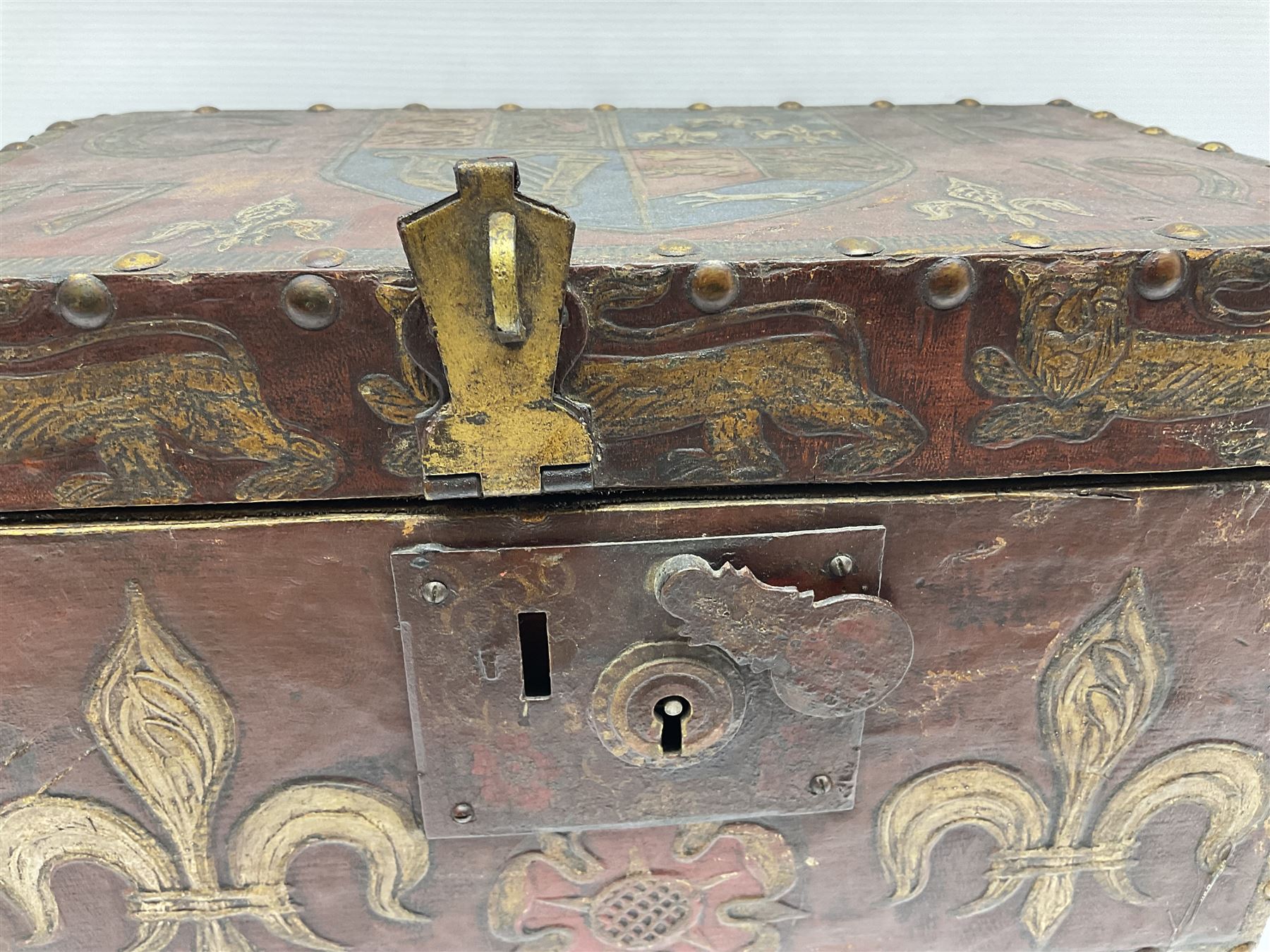 20th century box, decorated in faux leather with the royal coat of arms and GR 1719 to hinged cover, with fleur-de-lis, lion, crown and rose motifs throughout and studs to all edges, opening to reveal a purple velvet interior containing three removable wooden trays, H18.5cm