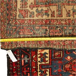Caucasian Shirvan hand-knotted runner, ivory field decorated with a vertical sequence of bold hexagonal and lozenge medallions, each enclosing stylized geometric motifs, flanked by angular floral latch-hook devices, field dominated by madder red  and ivory with subsidiary colours of indigo, brown, and turquoise, with fringe ends   