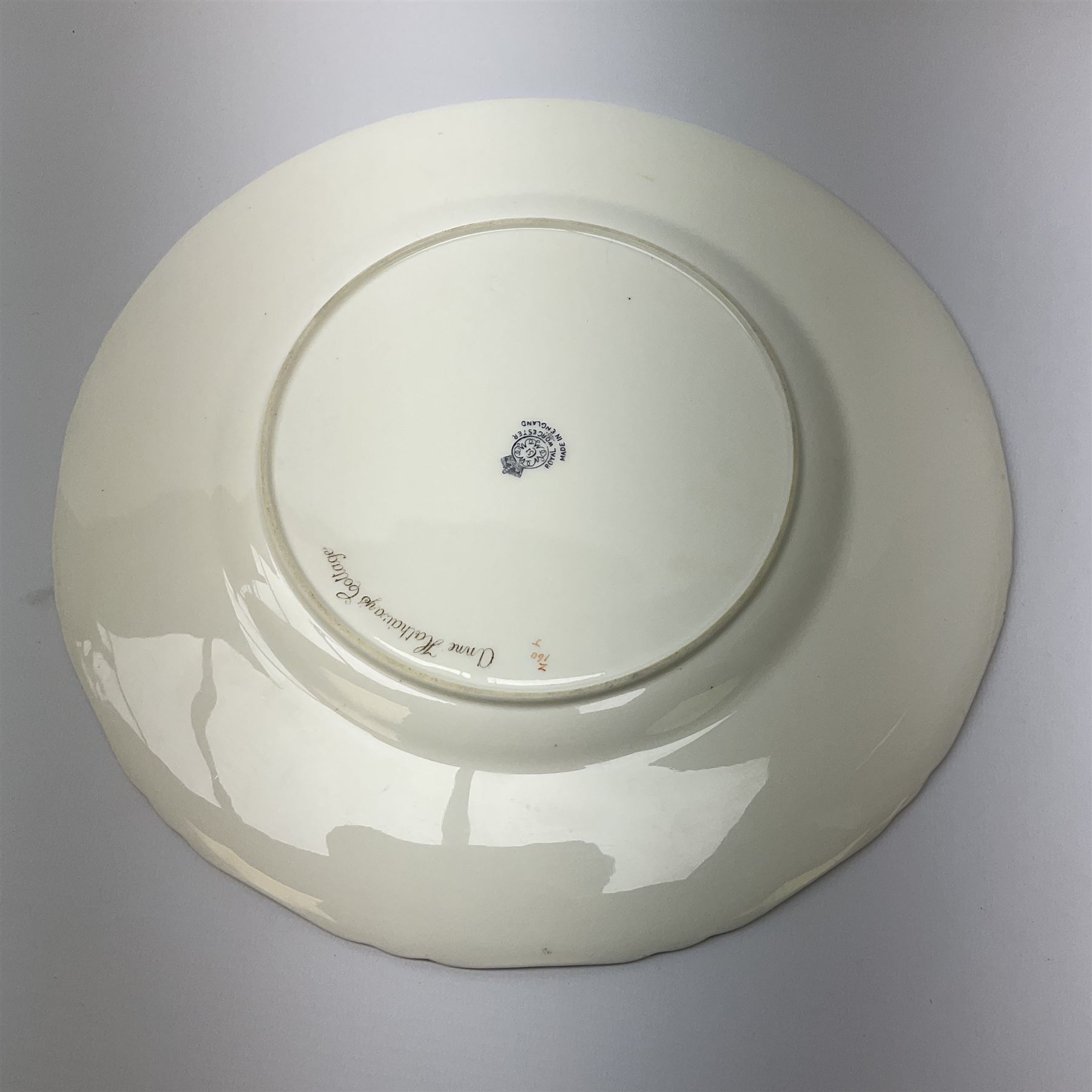 A Royal Worcester cabinet plate, decorated with and titled verso Anne Hathaway's Cottage, signed H Stinton, within a gilt rim, with black printed mark beneath, D27cm