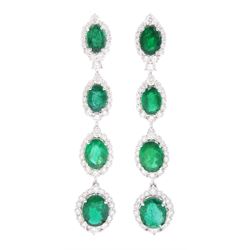 Pair of 18ct white gold graduating emerald and diamond pendant stud earrings, oval cut emerald and round brilliant cut cluster, suspending a single round brilliant cut diamond and three further emerald and diamond clusters, stamped, total emerald weight approx 8.65 carat, total diamond weight approx 3.30 carat