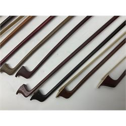 Fourteen predominantly brazilwood violin bows for spares or repair; and a Primavera cello bow; together with a quantity of violin accessories including Matrix SR-1000V tuner; resin/rosin; pitch pipes; bridges; tuning pegs; strings etc