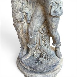 Composite garden statue group of Romeo and Juliet embracing, the couple adorned in Medieval dress standing on a naturalistic base with fallen flowers, raised on a Neoclassical fluted pedestal with Anthemion leaf motifs
