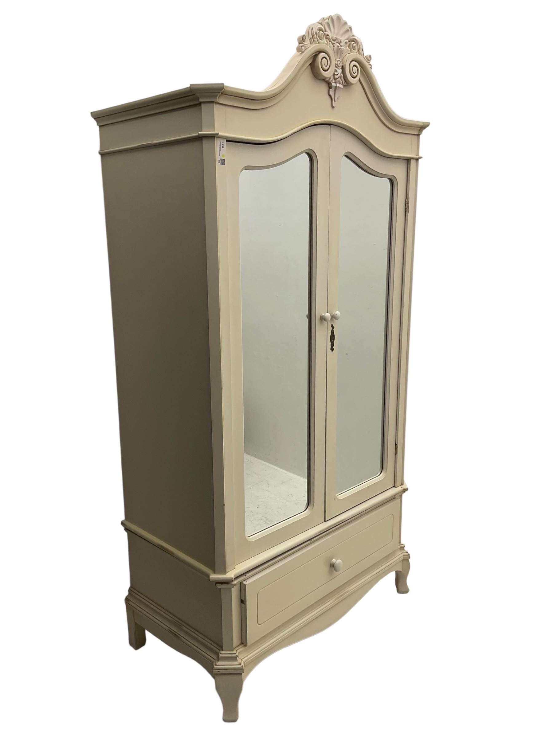 French design cream painted armoire wardrobe, shaped top with shell and flower head pediment, enclosed by two mirror glazed doors, the base fitted with single drawer
