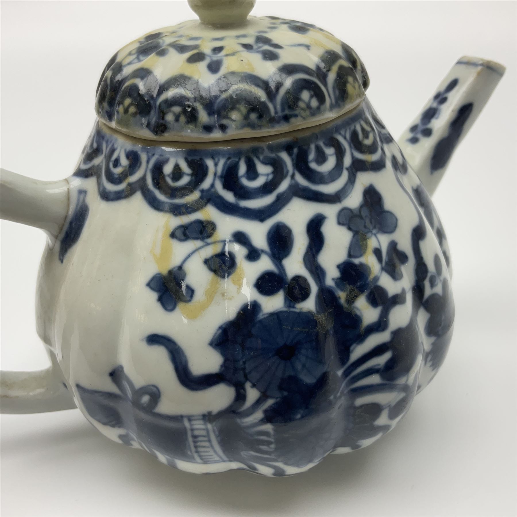 18th century Chinese blue and white teapot, painted with floral sprays, with lobed body and cover, H11cm