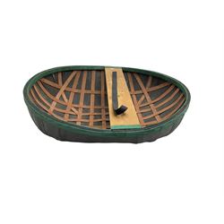 Coracle boat, comprised of woven planks and waterproof covering with single plank seat and strap