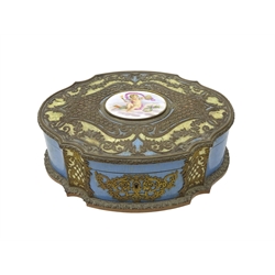  19th century French enamel casket of quatrefoil form, the gilt metal and mother-of pearl mounted lid inset with a hand painted oval plaque depicting Cupid, the lock inscribed Maison Boissier, the interior later converted to a sewing box with red satin lining and sewing implements including two mother-of-pearl handled stilettos, scissors, pin cushions etc Provenance: West Heslerton Hall  