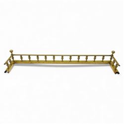 Edwardian brass fire kerb, with reeded and stepped base supporting baluster uprights and reeded top 