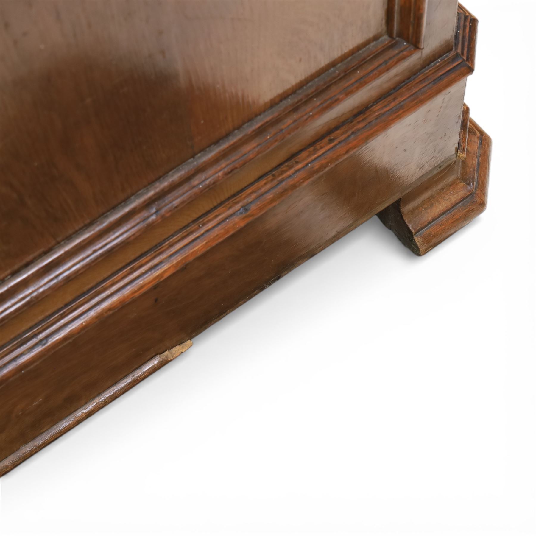 Late 19th century French provincial oak chest of drawers, moulded rectangular top with carved rope edge over four graduated long drawers with raised and fielded panels and ornate cast handles, canted angles and shaped apron below, standing on moulded block feet,