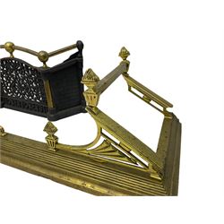 Early 20th century brass architectural fire fender; and an ornate metal fire front