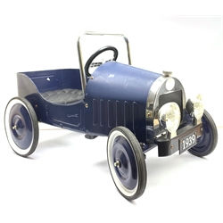 A blue painted metal pedal car, modelled as a 1930s motor vehicle, with a moulded plastic seat, single spoke steering wheel, front grille, and rubber tyre, L79cm. 