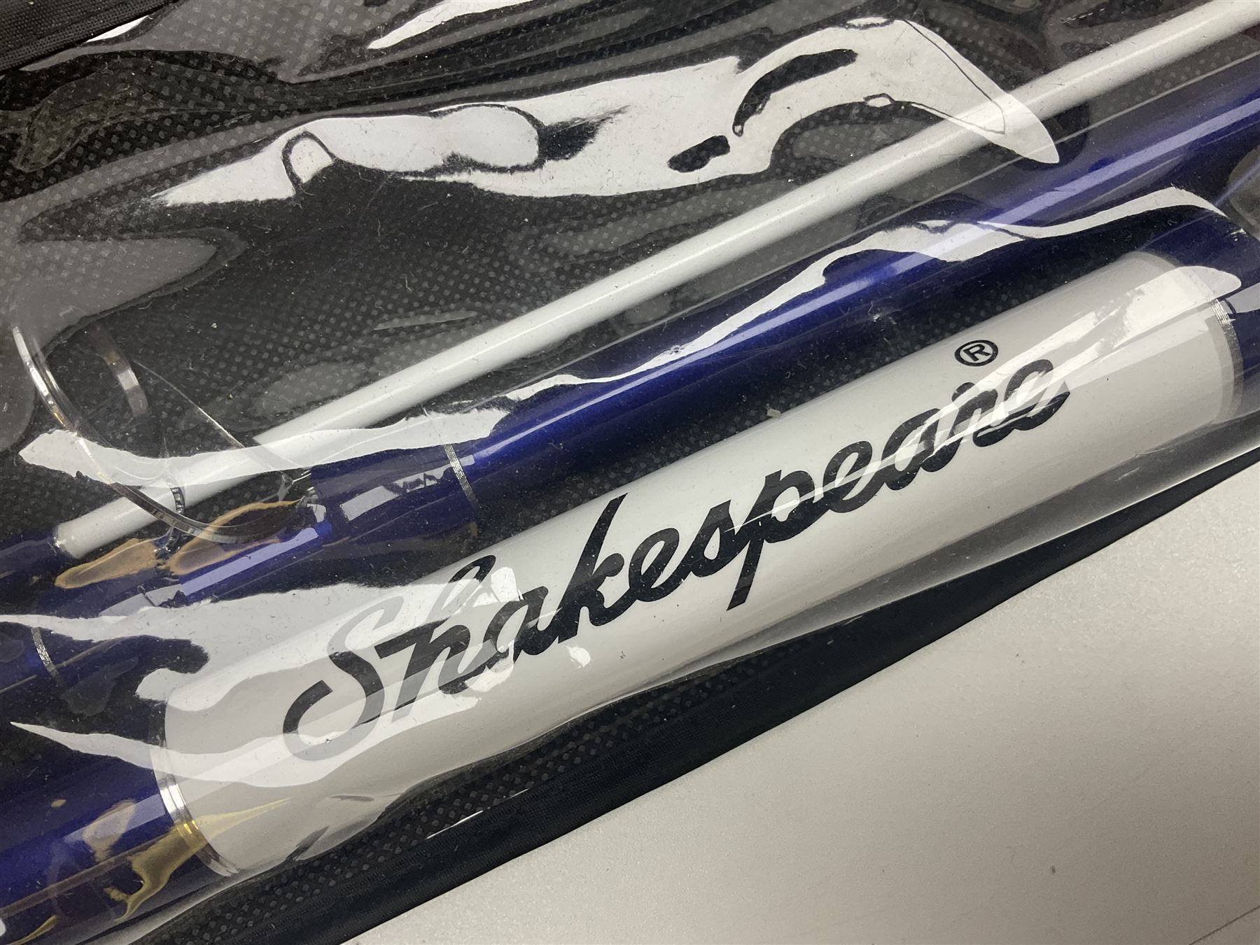 Collection of fishing memorabillia and equipment, including an Allcocks three piece split cane trout fly rod, Shakespeare Salt 3600 surf rod, two tackle bags, Old Red Seastreak multiplier reel, Sportext Saltwater fixed spool reel, fishing dvds, etc