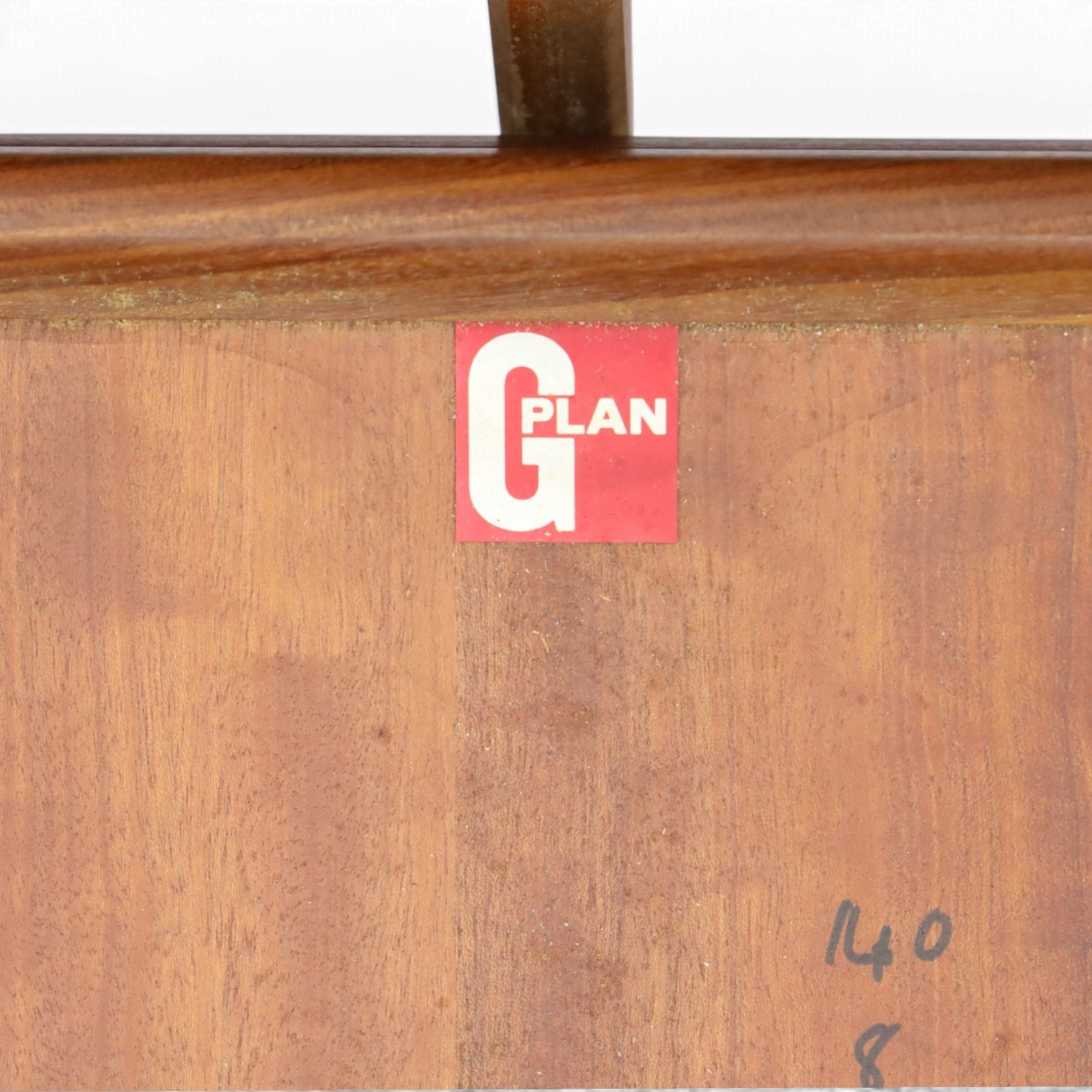 G Plan - Mid 20th century teak extending dining table and four chairs, oval top with stowed fold-over leaf extending to 208cm, raised on two shaped supports united by a stretcher 