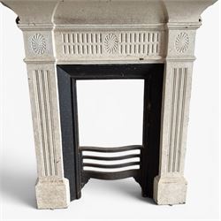 19th century Neoclassical design cast iron bedroom fire surround with fluted and rosette design, white painted finish with  black slip