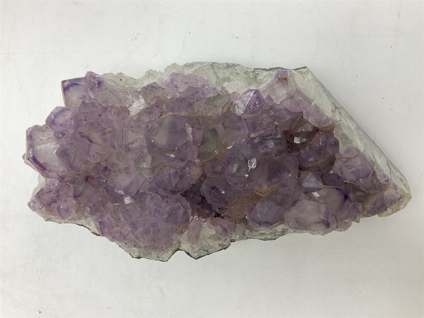 Amethyst crystal geode cluster, with well-defined crystals of various sizes, H10cm, L30cm