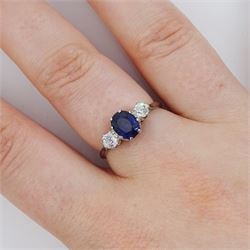 Early 20th century platinum three stone oval cut sapphire and old cut diamond ring, stamped, sapphire approx 1.10 carat, total diamond weight approx 0.30 carat