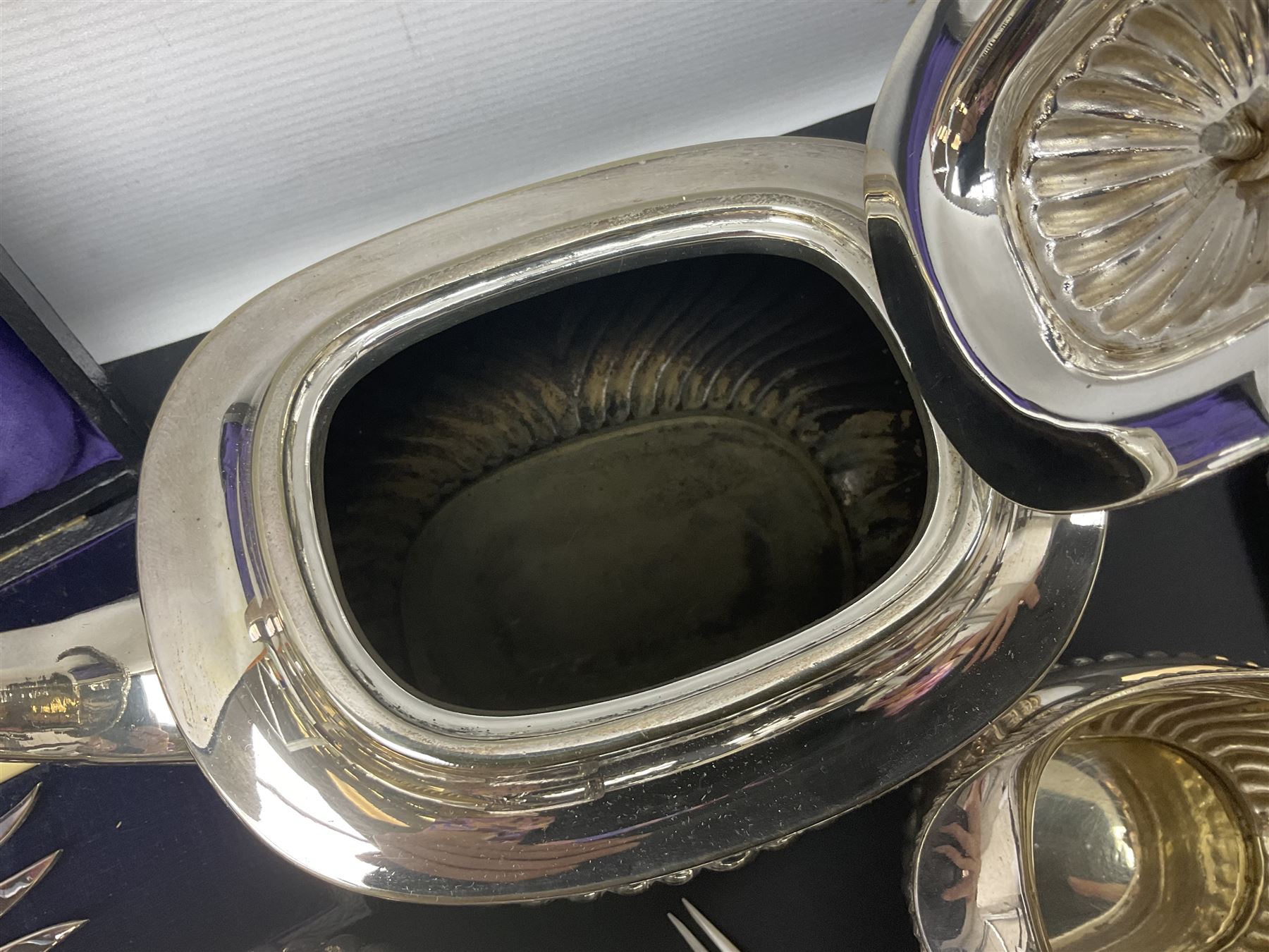 Mother of Pearl handled cutlery, with silver ferrules, comprising six fish knives and forks and six fruit knives and forks, the ferrules hallmarked Yates Brothers, Sheffield 1905, together with silver plated Edwardian three piece tea service and other flatware 