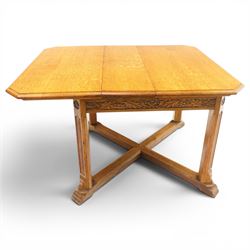 Waring & Gillow - Arts and Crafts oak draw-leaf extending dining table rectangular moulded top with chamfered corners, two additional leaves, carved frieze over fluted section supports, united by low X-shape stretchers