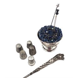 Group of silver sewing accessories, to include button hook, with silver leopard's head handle, hallmarks worn and indistinct, an Edwardian silver pin cushion, with embossed rose decoration and removable beaded pin cushion, hallmarked Charles Boyton & Son Ltd, London 1905 and five silver thimbles, including one continental silver example, all stamped or hallmarked 