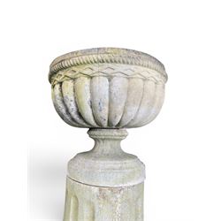 Four 20th century good quality weathered cast stone pedestal urns, circular lobed bowls with rope twist and lattice border, raised on squat base with fluted columns