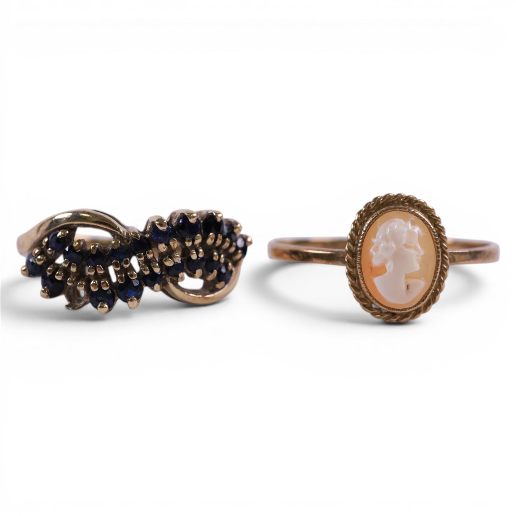 Four 9ct gold rings, including cameo and three stone set examples