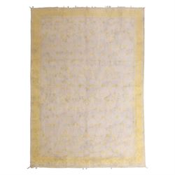 Tibetan wool rug, decorated with a pale cream ground and yellow all-over foliate design, e...
