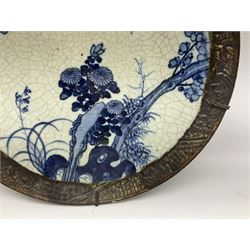 20th century Chinese blue and white crackle glaze charger, decorated with peonies, prunus blossom, and rockwork, within simulated bronze border, with character mark verso, D34cm