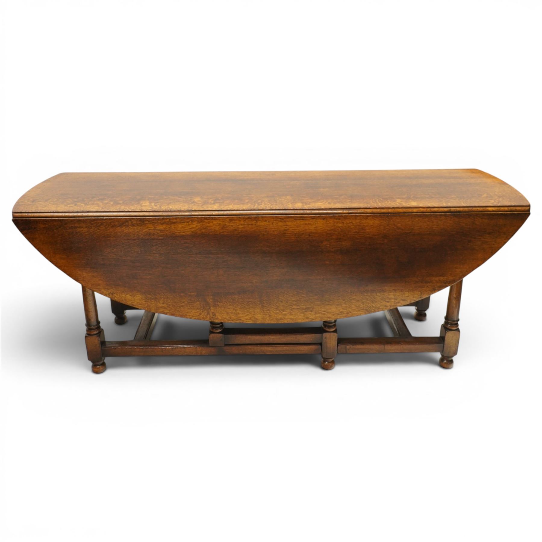 Titchmarsh & Goodwin - oak dropleaf wake table, large leaves with gateleg action, raised on turned supports united by stretchers, extends to 148cm