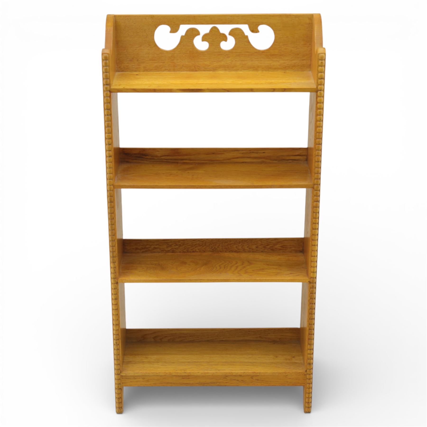 20th century small oak open bookcase, with pierced shaped cresting above four open shelves, beaded upright sides, shaped side panels, raised on shaped feet