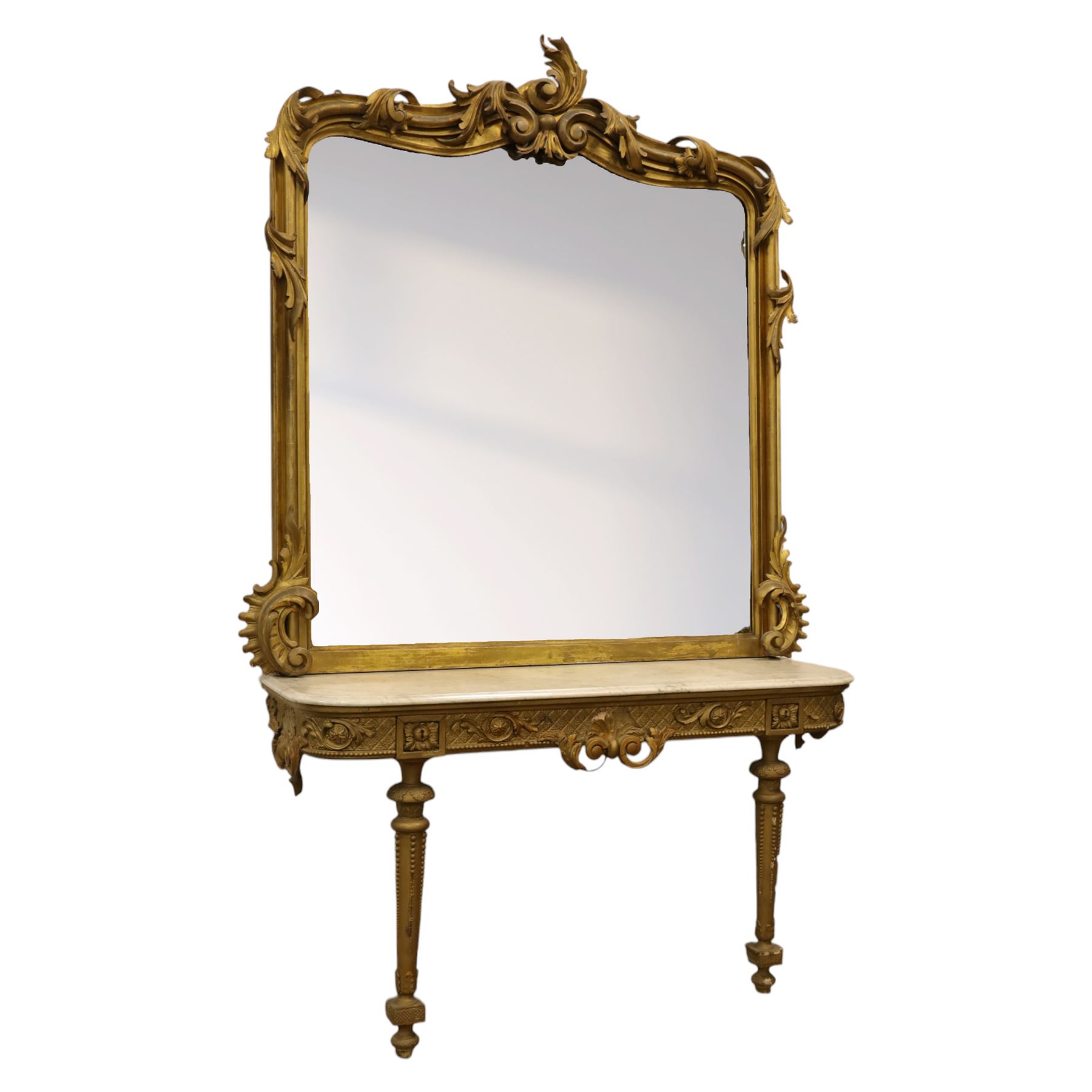 Large late 19th century Rococo revival giltwood and gesso pier mirror, the rounded rectangular frame with richly carved crest and scrolls with acanthus leaves and foliate ornamentation, above a giltwood console table with Carrara marble top and richly carved guilloche and ribbon tied laurel garland frieze, rosettes, and central scrollwork, raised upon tapered legs with beaded moulding and square block above with turned toupie style terminal  