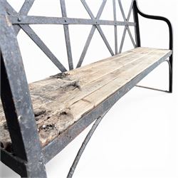 19th century and later Estate made wrought iron strapwork garden bench, the weathered wooden cresting rail over X-form strapwork back and slatted wooden seat