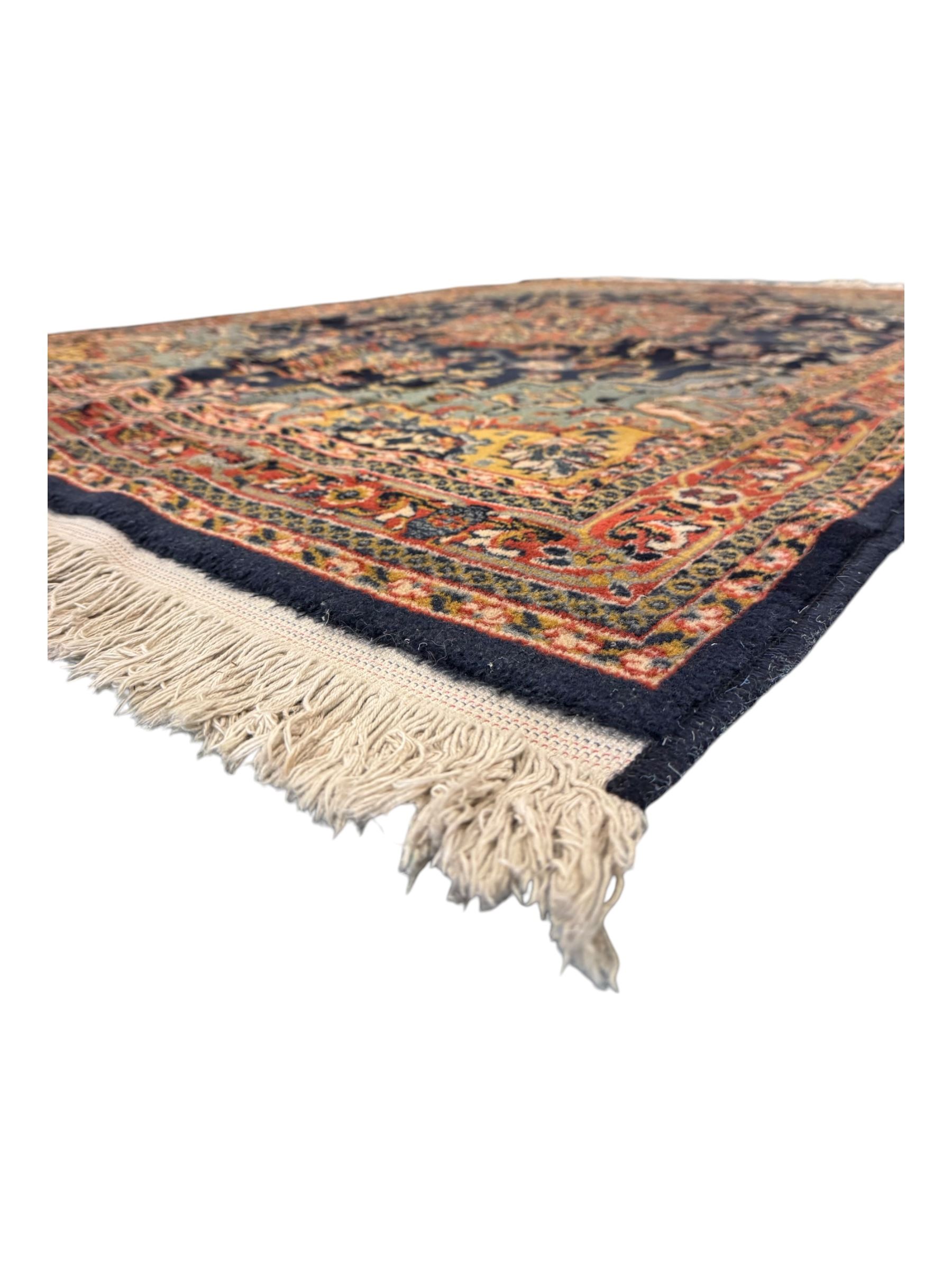Belgian Sultan woollen ground rug, central navy field densely decorated with floral sprays and geometric patterns (192cm x 135cm); handwoven tribal terracotta ground rug (121cm x 71cm); Persian crimson ground runner, all over stylised floral and foliate motifs (266cm x 94cm)