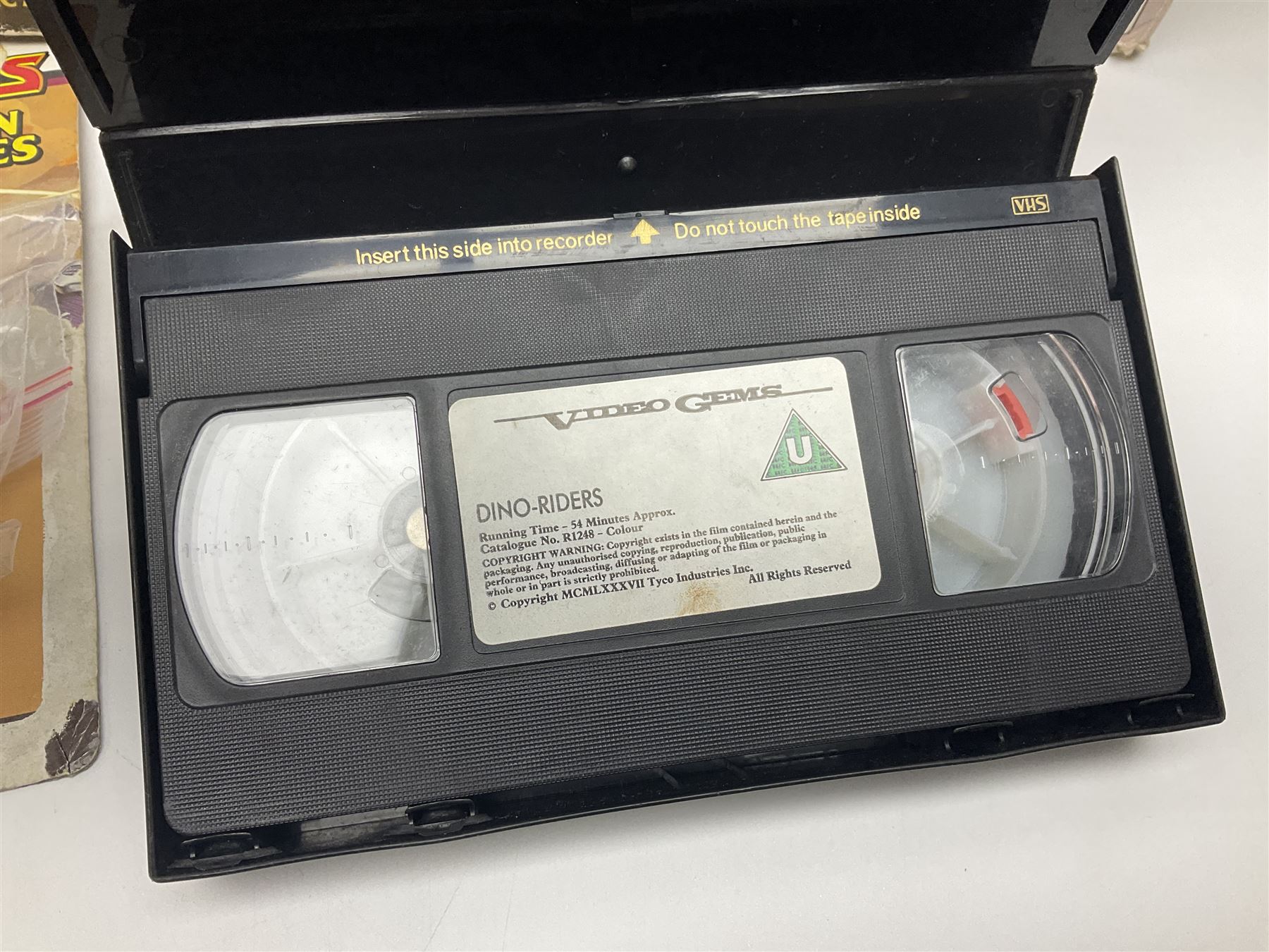 Dino-Riders 1980s by Tyco Action-GT, Stegosaurus with Tark and Vega Heroic Dino-Riders; Triceratops with Hammerhead and Sidewinder Evil Rulon Warriors; and Struthiomimus with Nimbus Heroic Dino-Rider; all boxed; two Action Figures, re-bagged on original card backing; and two VHS video tapes (6)