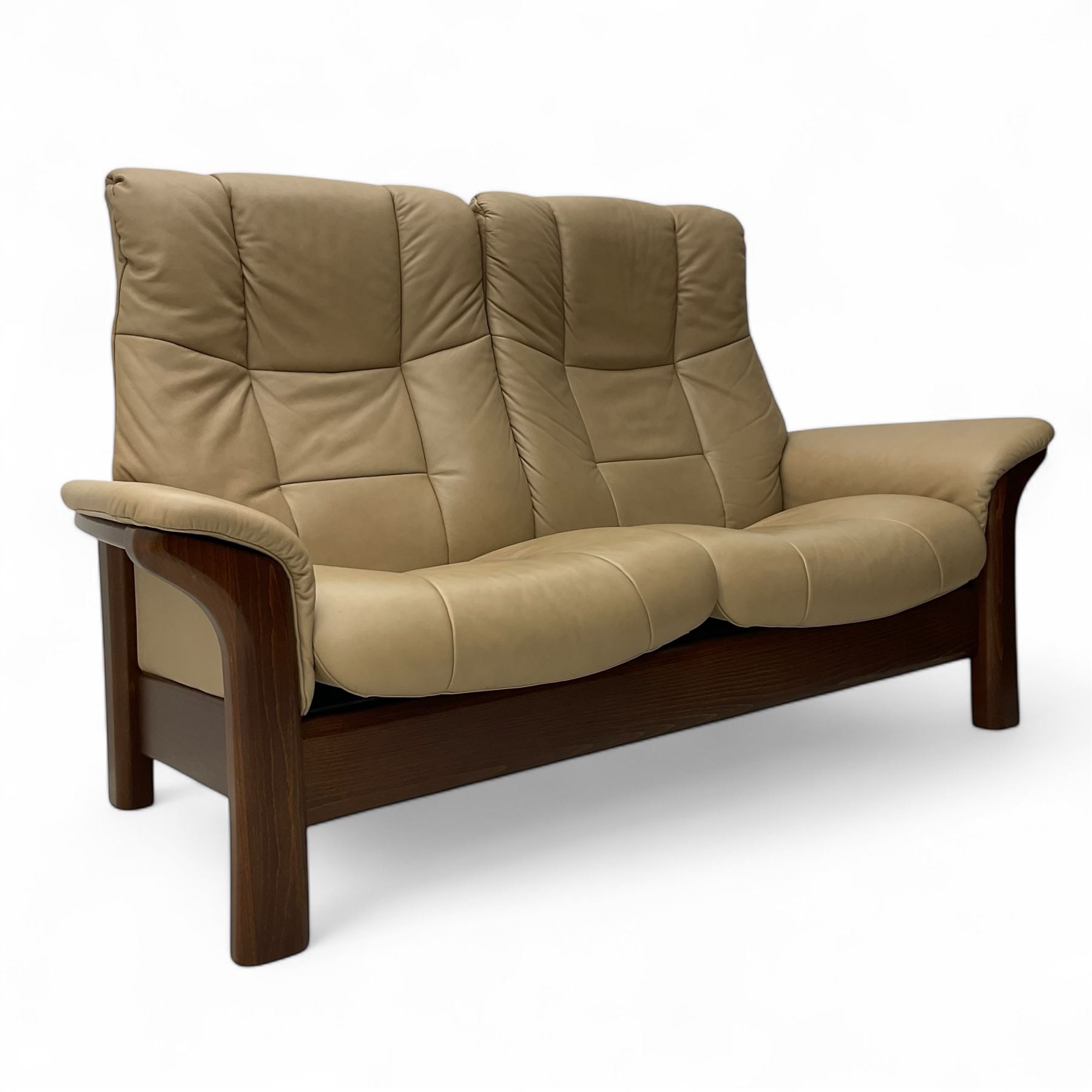 Ekornes Stressless - two-seat beech framed sofa, upholstered in beige-brown leather with stitched panel detailing, featuring curved armrests and high back supports with manual recline mechanism, raised on a dark-stained beech frame with sculpted supports