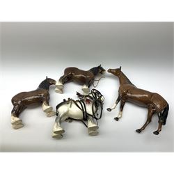 A Beswick large model of a Racehorse, model no 1564, together with three Beswick Shire Horses, to include a pair, each with printed marks beneath. (4). 