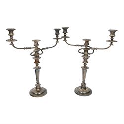 Pair of silver plated three branch candelabra, each with three urn-shaped sconces, with scroll arms, tapering stem upon a circular base, together with silver plated wine flagon
