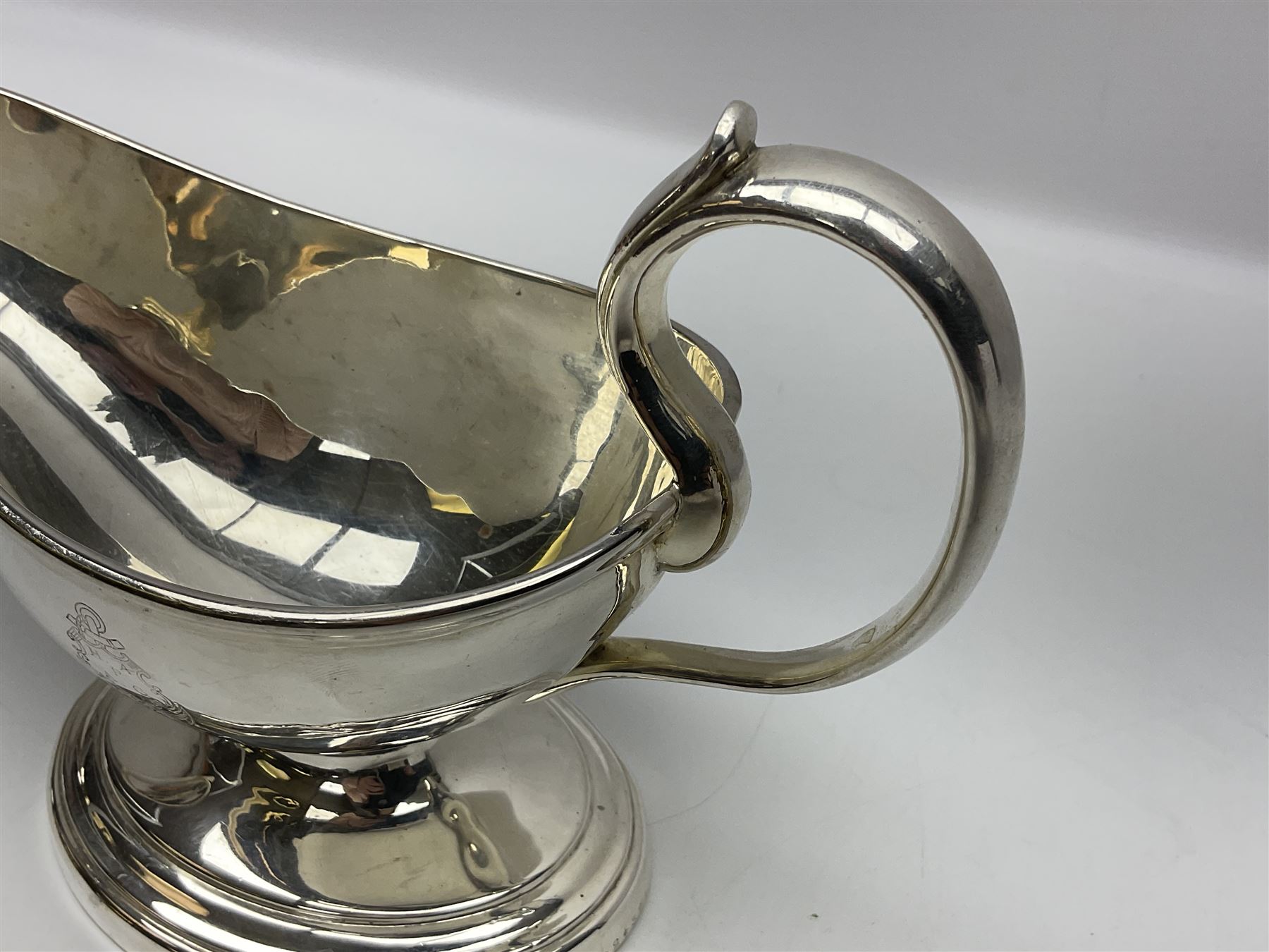 Christofle silver-plated sauce boat, of typical plain form, with capped C scroll handle and engraved anchor crest to body, upon a stepped oval foot, stamped 22 Christofle to base, including handle H14cm