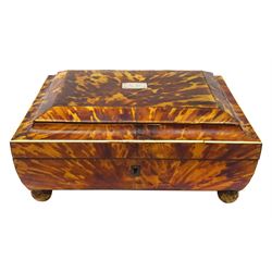 19th century tortoiseshell sewing box, of sarcophagal form upon four foliate detailed brass ball feet, the hinged cover edged in ivory with initialled silver plaque to centre, opening to reveal a silk lined interior, H9.5cm W22.5cm D18cm